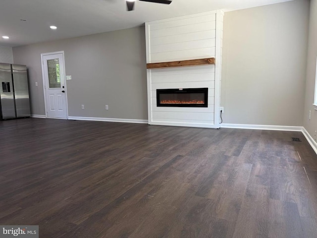 543 Elk Creek Rd, Mineral, VA 23117 - unfurnished living room featuring dark wood-type flooring, ceiling fan, a large fireplace, and recessed lighting