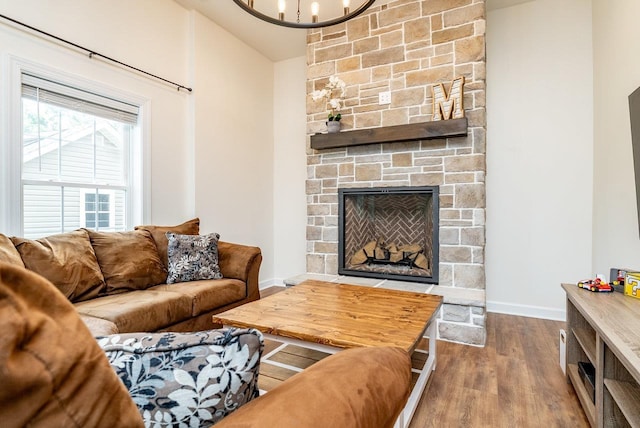 4517 Wiltshire St, Rockingham, VA 22802 - living room with dark wood-type flooring, a chandelier, baseboards, and a stone fireplace