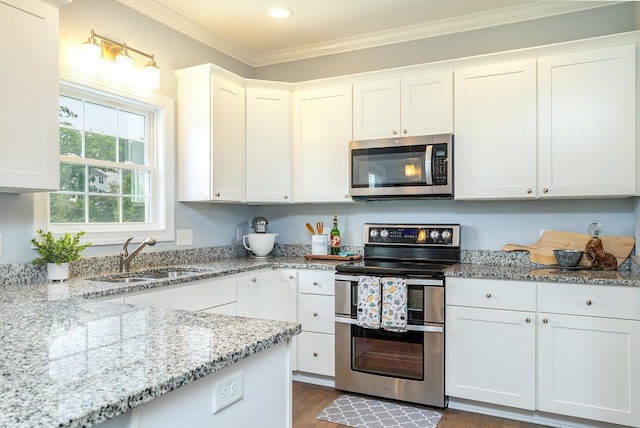 4517 Wiltshire St, Rockingham, VA 22802 - kitchen with stainless steel appliances, a sink, white cabinets, light stone counters, and ornamental molding