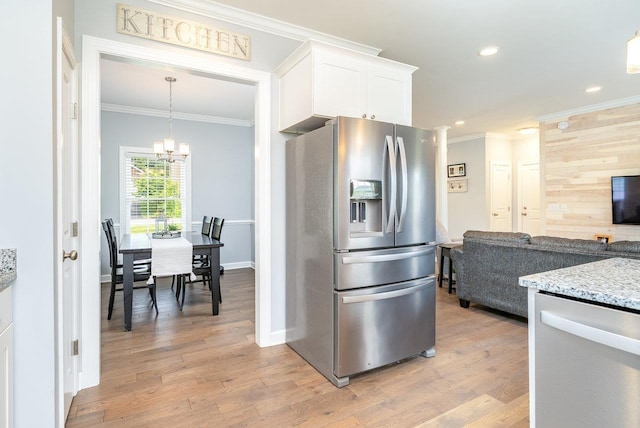 4517 Wiltshire St, Rockingham, VA 22802 - kitchen with appliances with stainless steel finishes, crown molding, light stone counters, white cabinets, and light wood finished floors