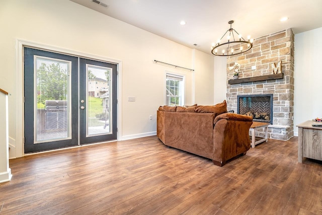 4517 Wiltshire St, Rockingham, VA 22802 - living room with wood finished floors, a chandelier, a stone fireplace, french doors, and recessed lighting