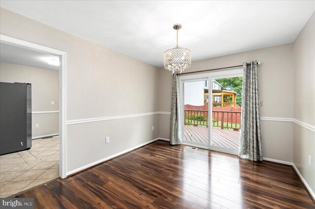 500 Maple Grove Dr, Fredericksburg, VA 22407 - spare room with a chandelier and wood finished floors
