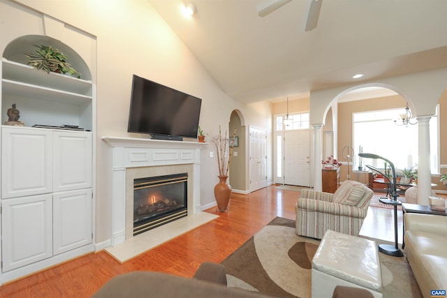 515 Broadleaf Way, Charlottesville, VA 22911 - living room with light wood-type flooring, arched walkways, decorative columns, a high end fireplace, and lofted ceiling