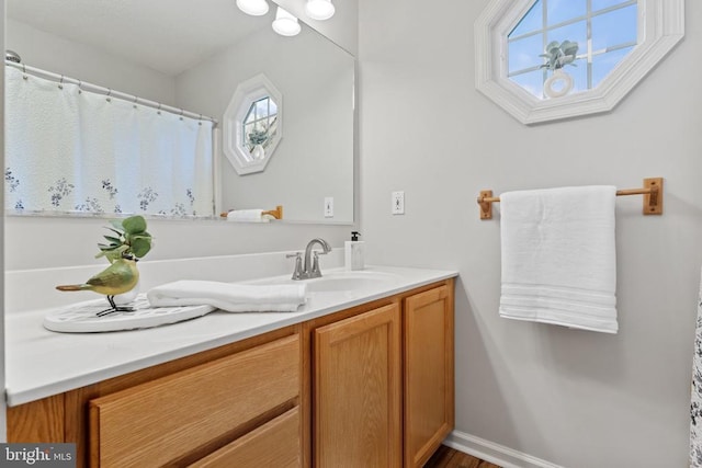 full bathroom featuring baseboards and vanity