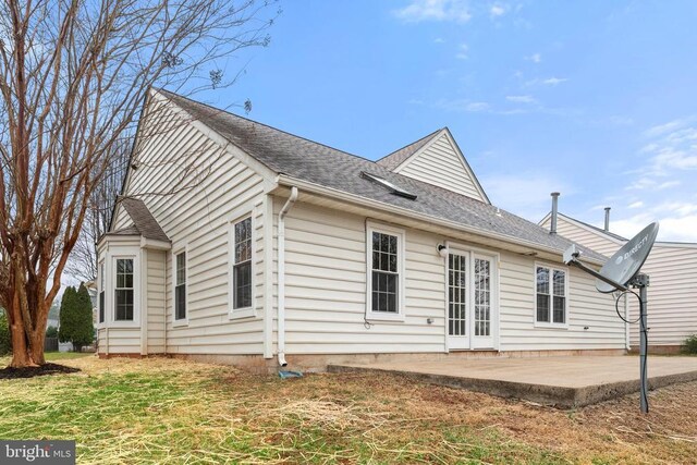 back of property featuring a patio area and roof with shingles