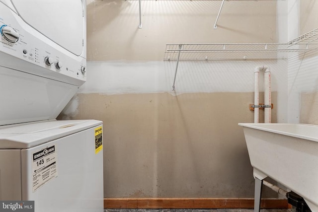 laundry room featuring stacked washer and dryer, a sink, and laundry area