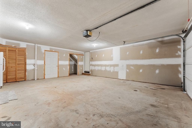 garage with a garage door opener and freestanding refrigerator