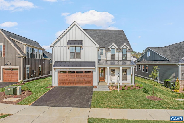 33 Fowler St Unit C, Charlottesville, VA 22911 - view of front of property with an attached garage, board and batten siding, a front yard, driveway, and a standing seam roof