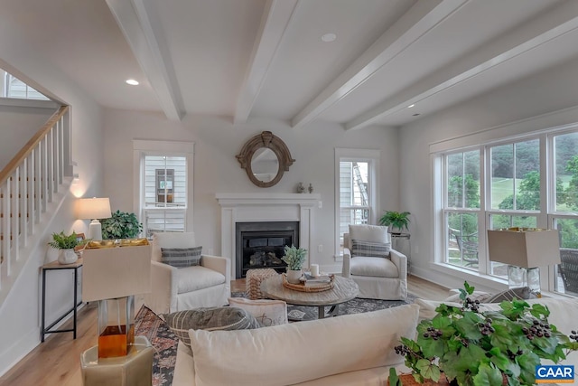 33 Fowler St Unit C, Charlottesville, VA 22911 - living room with stairs, a wealth of natural light, a glass covered fireplace, and beam ceiling