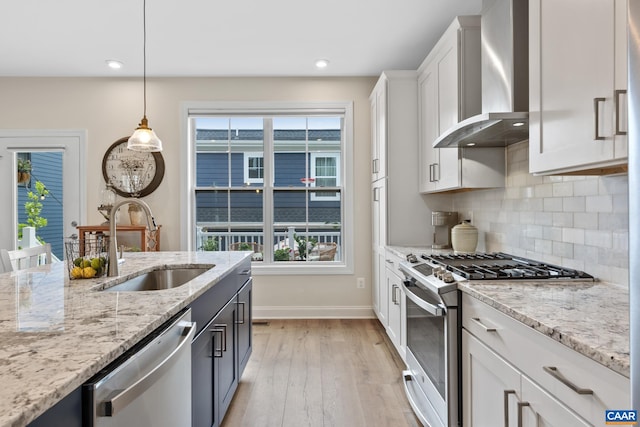 6211 Raynor Pl, Crozet, VA 22932 - kitchen featuring wall chimney range hood, appliances with stainless steel finishes, a sink, baseboards, and light wood-style floors