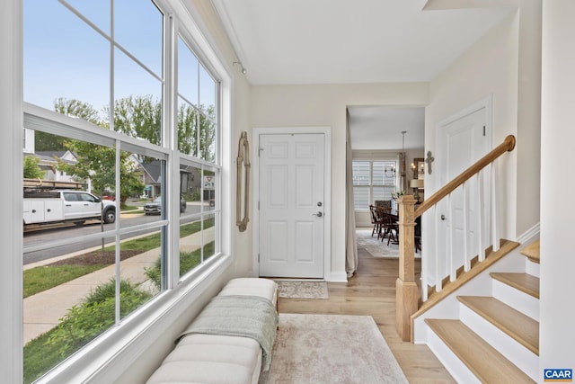 6211 Raynor Pl, Crozet, VA 22932 - entryway with light wood-style flooring, a chandelier, stairs, and baseboards