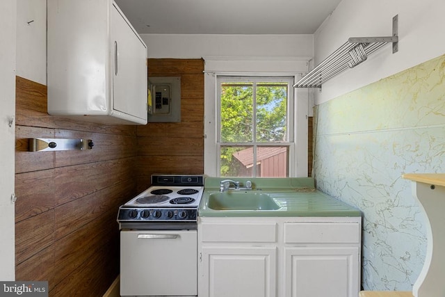 410 W St N, Culpeper, VA 22701 - kitchen featuring electric stove, a sink, light countertops, electric panel, and white cabinetry