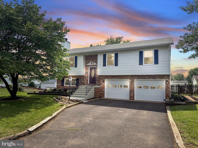 1625 Harrier Ln, Culpeper, VA 22701 - split foyer home featuring brick siding, a garage, asphalt driveway, and a chimney