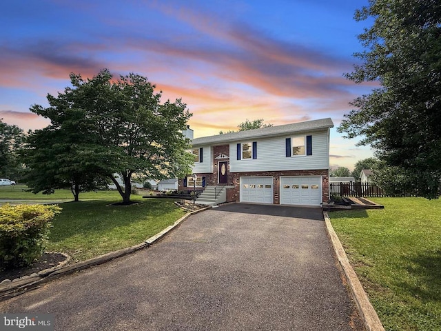 1625 Harrier Ln, Culpeper, VA 22701 - split foyer home featuring brick siding, driveway, an attached garage, and a front yard