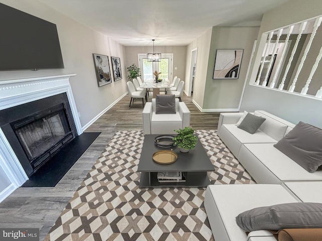 1625 Harrier Ln, Culpeper, VA 22701 - living room featuring a chandelier, dark wood-type flooring, and a fireplace