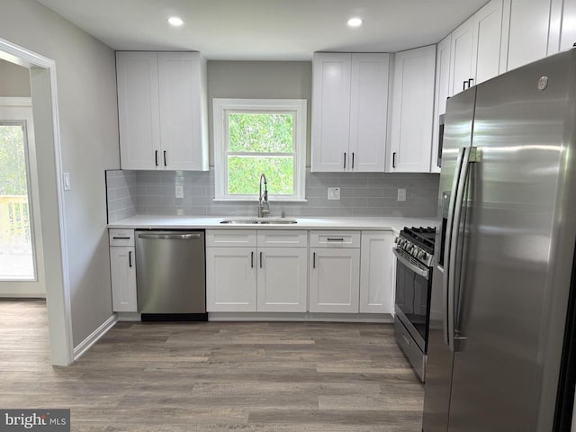 1625 Harrier Ln, Culpeper, VA 22701 - kitchen featuring stainless steel appliances, wood finished floors, light countertops, white cabinetry, and recessed lighting