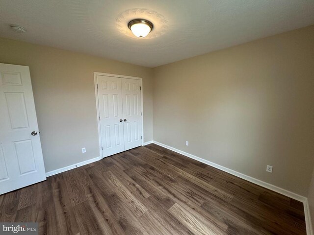 218 Honeyville Rd, Stanley, VA 22851 - unfurnished bedroom featuring baseboards, dark wood-style flooring, and a closet