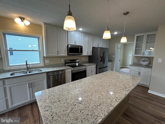 218 Honeyville Rd, Stanley, VA 22851 - kitchen with stainless steel appliances, a sink, a kitchen island, dark wood-style flooring, and glass insert cabinets