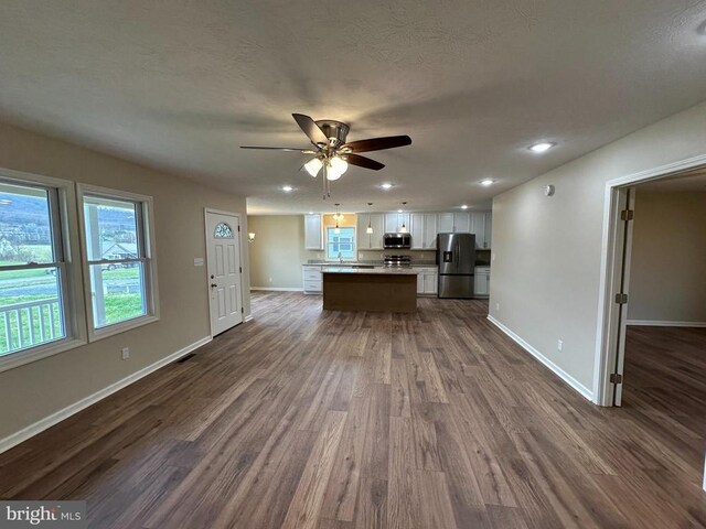 218 Honeyville Rd, Stanley, VA 22851 - kitchen with stainless steel appliances, white cabinets, dark wood finished floors, baseboards, and recessed lighting