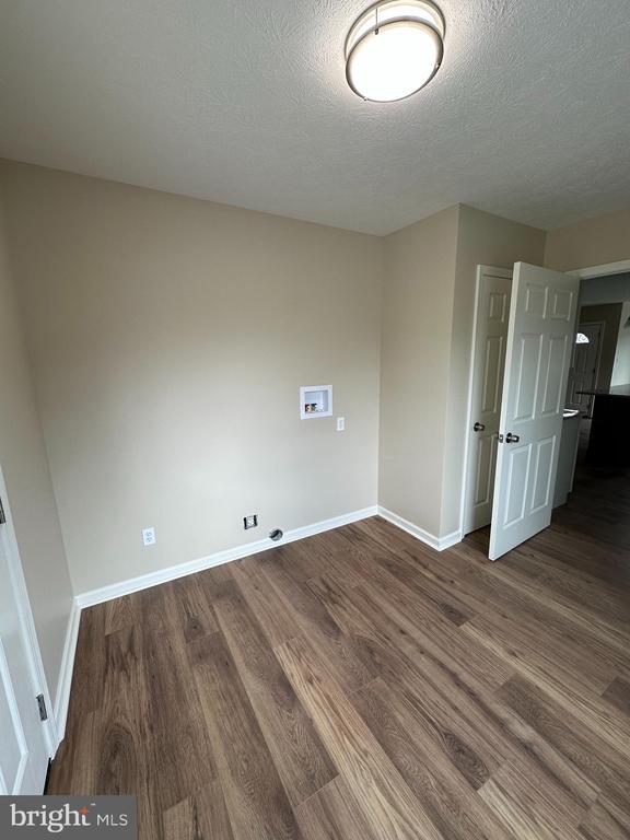 218 Honeyville Rd, Stanley, VA 22851 - empty room with baseboards, wood finished floors, and a textured ceiling