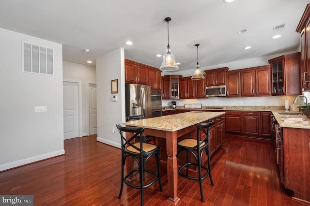 11407 Osprey Trl, Spotsylvania, VA 22551 - kitchen with a center island, a sink, stainless steel appliances, visible vents, and dark wood-type flooring