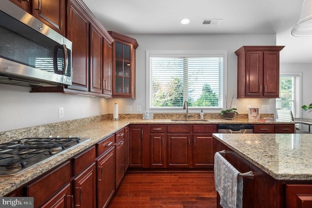 11407 Osprey Trl, Spotsylvania, VA 22551 - kitchen with glass insert cabinets, a sink, dark wood-style flooring, appliances with stainless steel finishes, and light stone counters