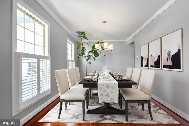 11407 Osprey Trl, Spotsylvania, VA 22551 - dining room with an inviting chandelier, ornamental molding, baseboards, and wood finished floors