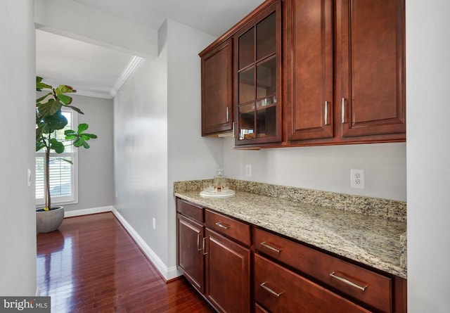 11407 Osprey Trl, Spotsylvania, VA 22551 - kitchen with light stone counters, baseboards, ornamental molding, and dark wood-style floors