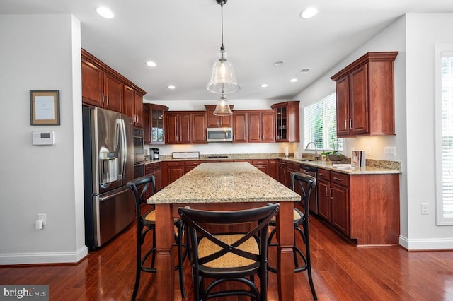 11407 Osprey Trl, Spotsylvania, VA 22551 - kitchen featuring a kitchen island, light stone counters, stainless steel appliances, and baseboards