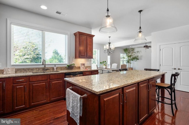 11407 Osprey Trl, Spotsylvania, VA 22551 - kitchen featuring a sink, a center island, a kitchen bar, and dark wood-type flooring