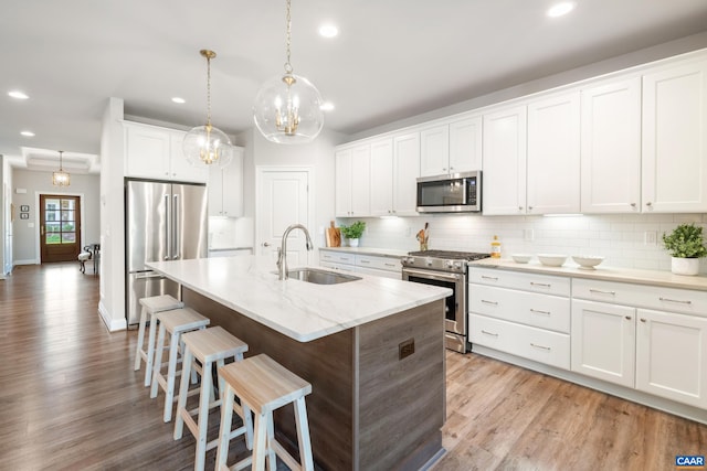 312 Avondale Ln, Crozet, VA 22932 - kitchen with stainless steel appliances, recessed lighting, tasteful backsplash, light wood-type flooring, and a breakfast bar area