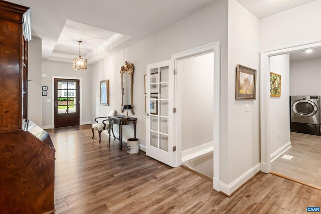 312 Avondale Ln, Crozet, VA 22932 - entrance foyer featuring washer / dryer, light wood-style floors, a raised ceiling, and a chandelier