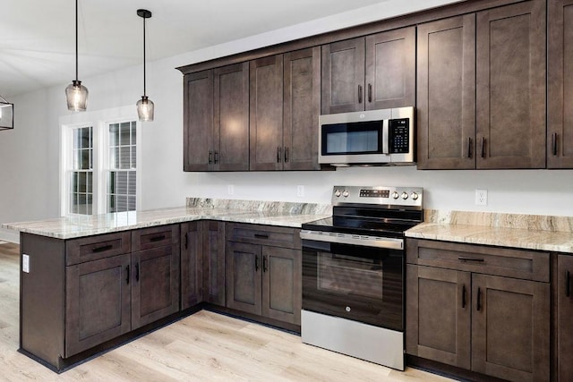 kitchen with dark brown cabinets, hanging light fixtures, kitchen peninsula, stainless steel appliances, and light stone countertops