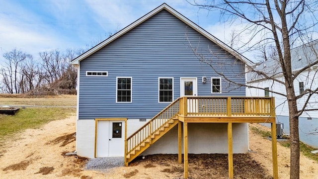 rear view of house featuring a deck and central air condition unit