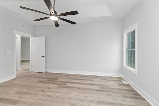 empty room featuring ceiling fan and light wood-type flooring