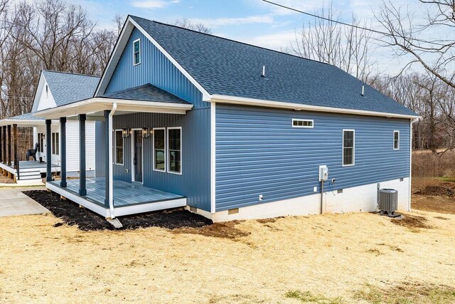 back of property with central AC unit and covered porch