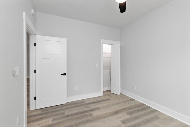 unfurnished bedroom with ceiling fan and light hardwood / wood-style floors