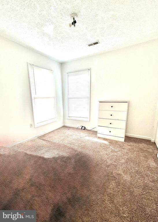 588 Meadowbrook Dr, Culpeper, VA 22701 - unfurnished bedroom with carpet and a textured ceiling