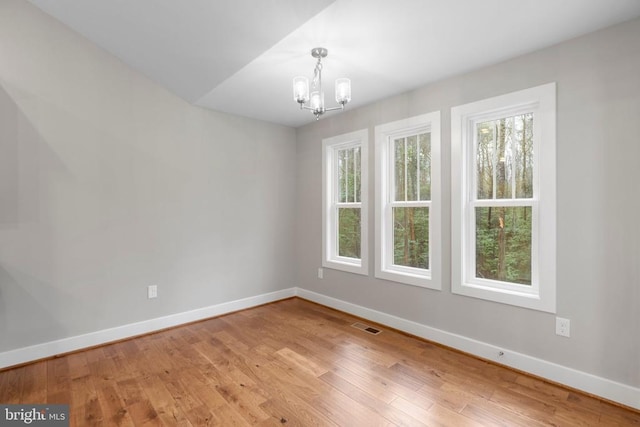 9712 Sutter Rd, Partlow, VA 22534 - unfurnished room featuring a chandelier, baseboards, and light wood-type flooring