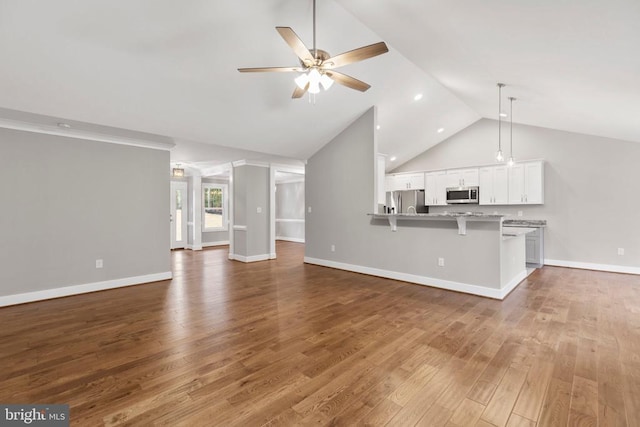 9712 Sutter Rd, Partlow, VA 22534 - unfurnished living room with a ceiling fan, high vaulted ceiling, wood finished floors, and baseboards