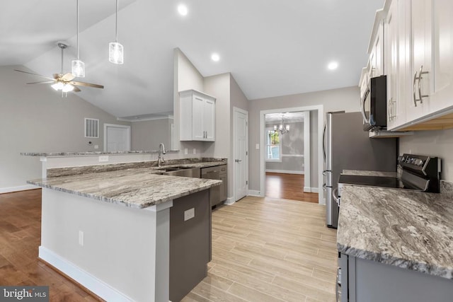 9712 Sutter Rd, Partlow, VA 22534 - kitchen with lofted ceiling, stainless steel microwave, a peninsula, baseboards, and a sink