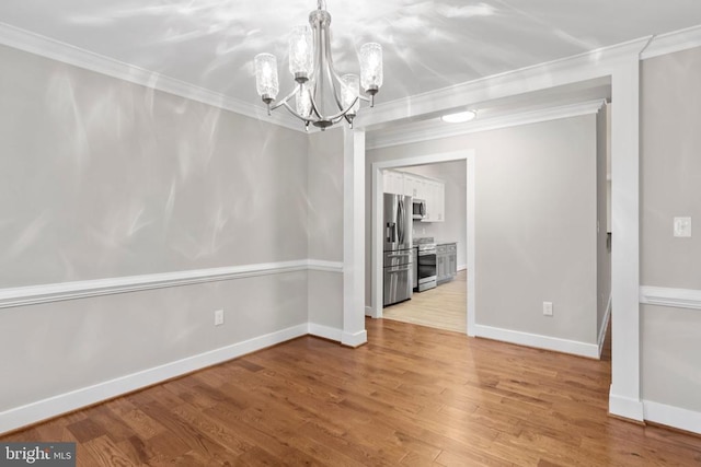 9712 Sutter Rd, Partlow, VA 22534 - unfurnished dining area featuring a chandelier, ornamental molding, light wood-style floors, and baseboards