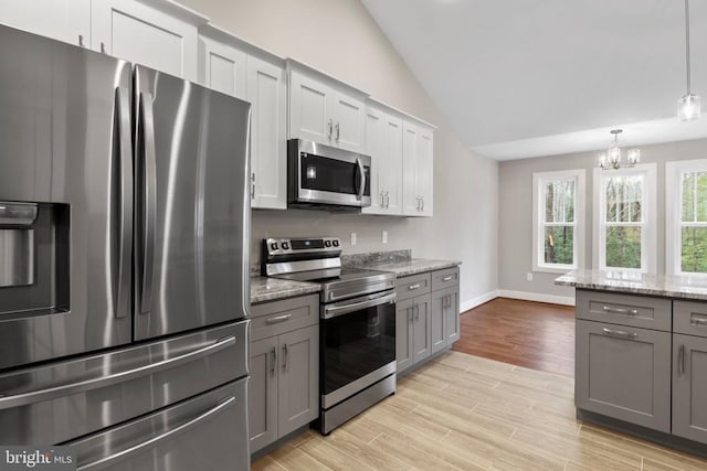 9712 Sutter Rd, Partlow, VA 22534 - kitchen featuring stainless steel appliances, gray cabinetry, lofted ceiling, a chandelier, and light wood finished floors