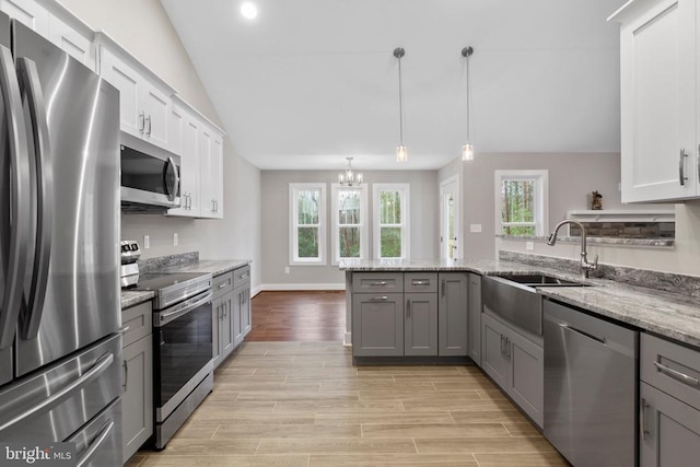 9712 Sutter Rd, Partlow, VA 22534 - kitchen with appliances with stainless steel finishes, a sink, gray cabinets, a peninsula, and vaulted ceiling