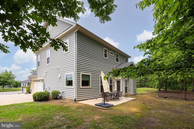 11402 Osprey Trl, Spotsylvania, VA 22551 - back of house with an attached garage, a lawn, driveway, and a patio area