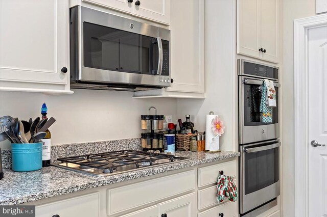11402 Osprey Trl, Spotsylvania, VA 22551 - kitchen with appliances with stainless steel finishes, white cabinetry, and light stone countertops