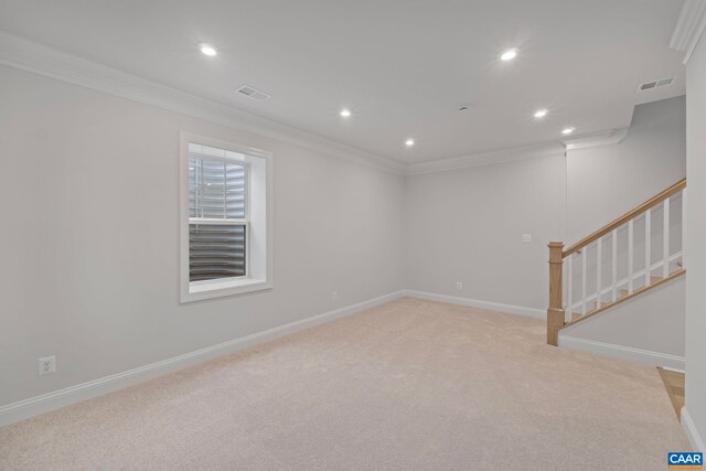 below grade area with visible vents, light carpet, ornamental molding, and recessed lighting