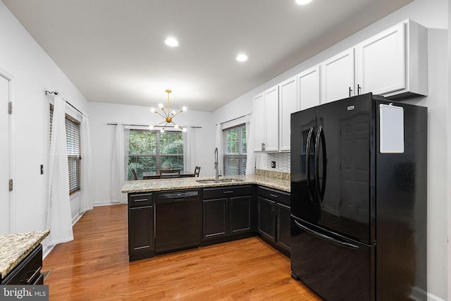 9900 Wellford Ct, Fredericksburg, VA 22407 - kitchen with black appliances, a sink, a chandelier, white cabinets, and a peninsula