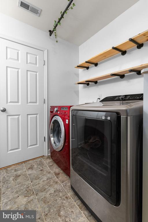9900 Wellford Ct, Fredericksburg, VA 22407 - laundry area with washing machine and clothes dryer and tile patterned floors
