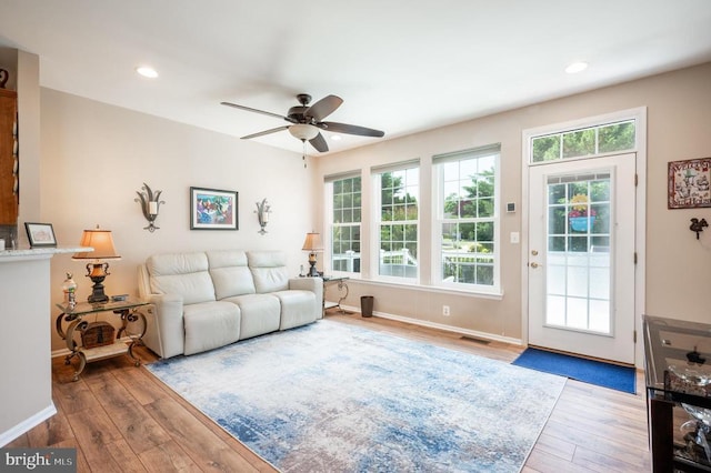  - living room featuring hardwood / wood-style floors, a ceiling fan, baseboards, and recessed lighting